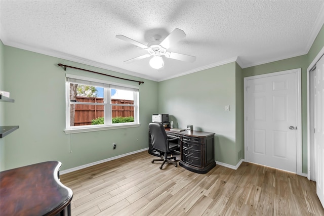 home office with a textured ceiling, ornamental molding, ceiling fan, and light wood-type flooring