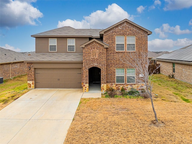 front facade featuring a garage and a front lawn