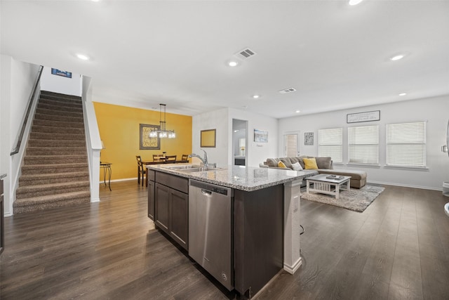 kitchen featuring pendant lighting, sink, dark brown cabinetry, an island with sink, and stainless steel dishwasher