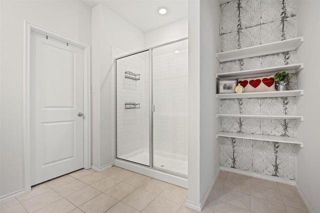 bathroom featuring a shower with shower door and tile patterned flooring