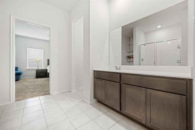 bathroom featuring vanity, tile patterned flooring, and a shower with door