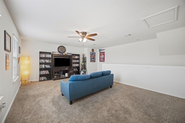 living room with ceiling fan and carpet