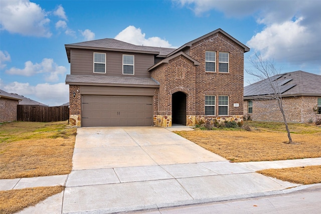 view of front property featuring a garage and a front yard