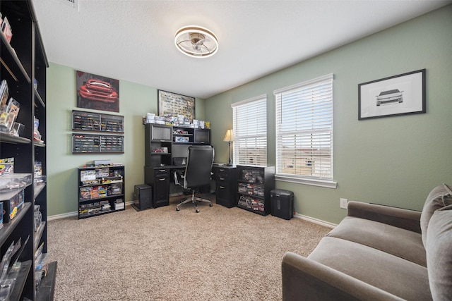 office with carpet flooring and a textured ceiling