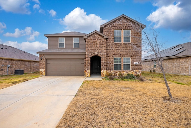 view of property with a garage, a front lawn, and central air condition unit