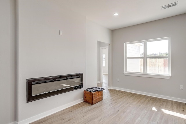 2604 Creekview Dr, Granbury, TX 76048 - unfurnished living room featuring light wood finished floors, baseboards, and recessed lighting