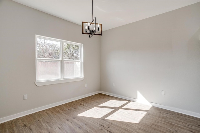 2604 Creekview Dr, Granbury, TX 76048 - unfurnished room featuring wood finished floors, a chandelier, and baseboards
