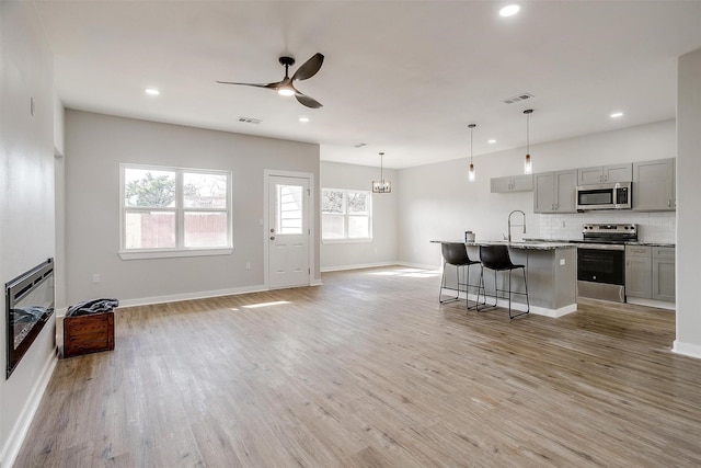 2604 Creekview Dr, Granbury, TX 76048 - living area featuring a ceiling fan, baseboards, recessed lighting, and light wood finished floors
