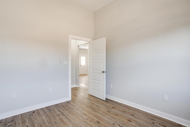 2604 Creekview Dr, Granbury, TX 76048 - empty room featuring baseboards, light wood-style flooring, and a high ceiling