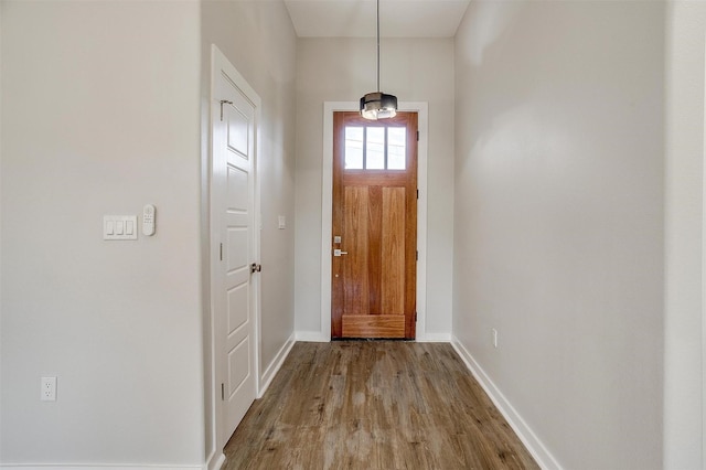 doorway with hardwood / wood-style flooring