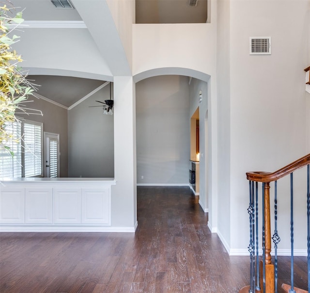 entryway featuring crown molding, ceiling fan, dark hardwood / wood-style flooring, and high vaulted ceiling