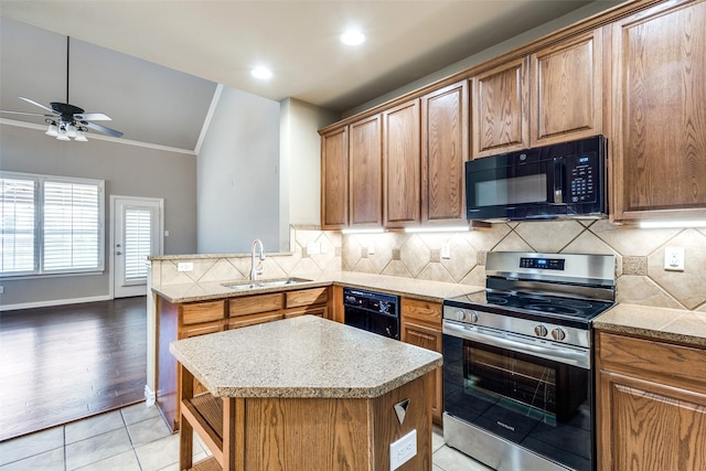 kitchen featuring tasteful backsplash, sink, a kitchen island, and black appliances