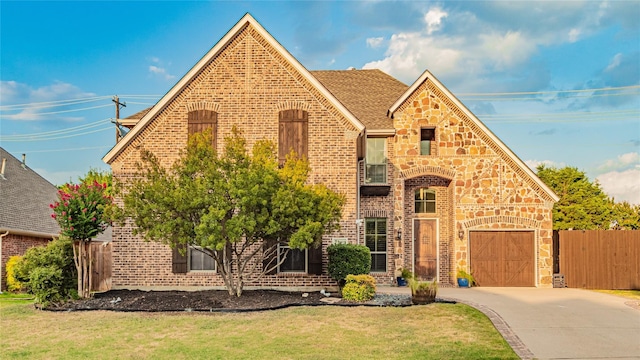 view of front of property featuring a garage and a front lawn