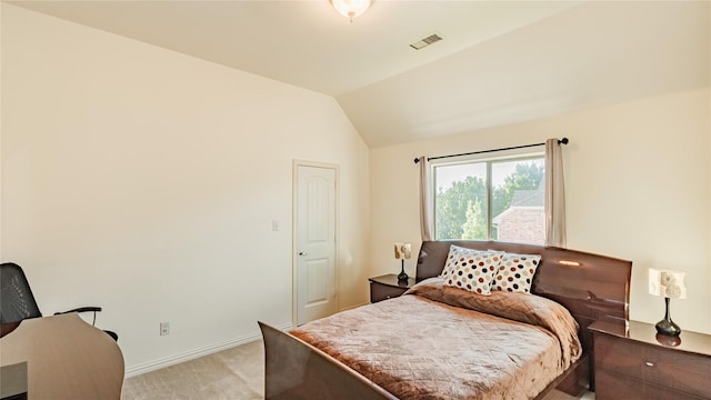 carpeted bedroom with lofted ceiling