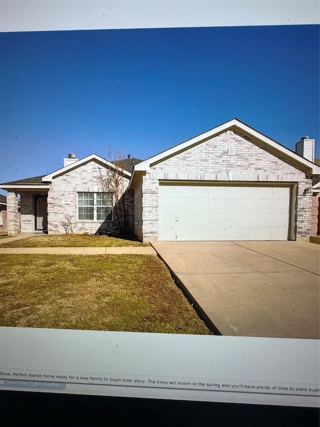 ranch-style house featuring a garage and a front yard