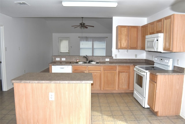 kitchen featuring sink, white appliances, a center island, kitchen peninsula, and ceiling fan