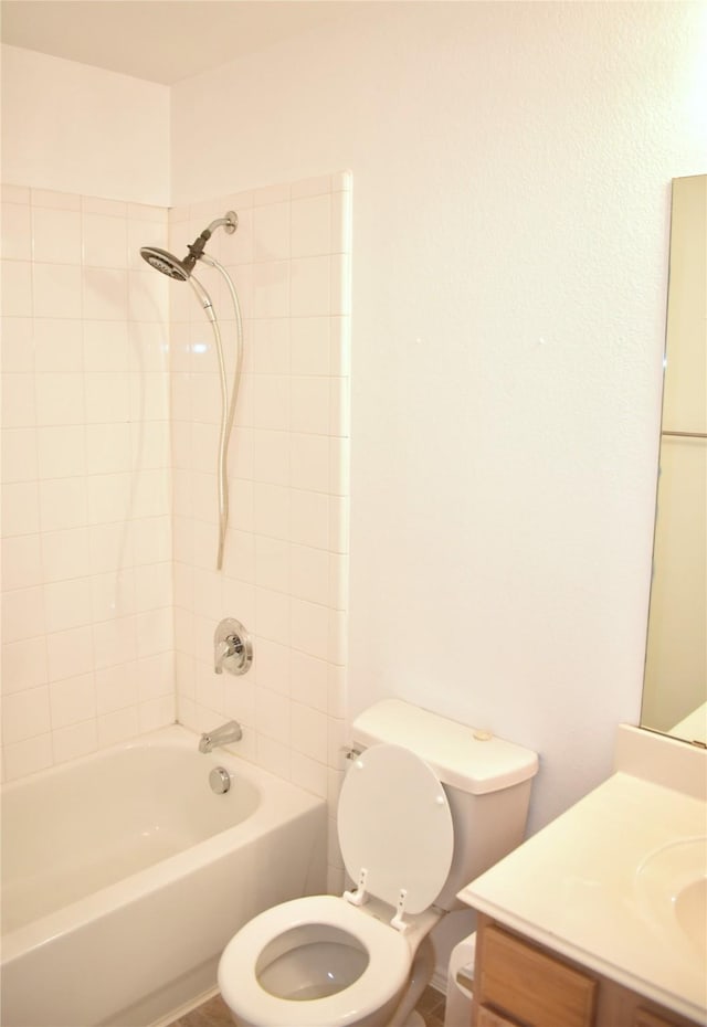 full bathroom featuring vanity, toilet, and tiled shower / bath