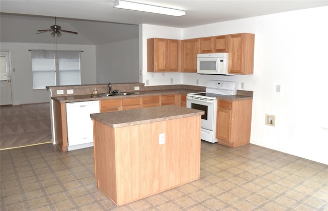 kitchen featuring sink, white appliances, kitchen peninsula, a kitchen island, and ceiling fan