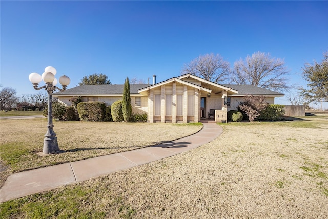 ranch-style home with a front lawn