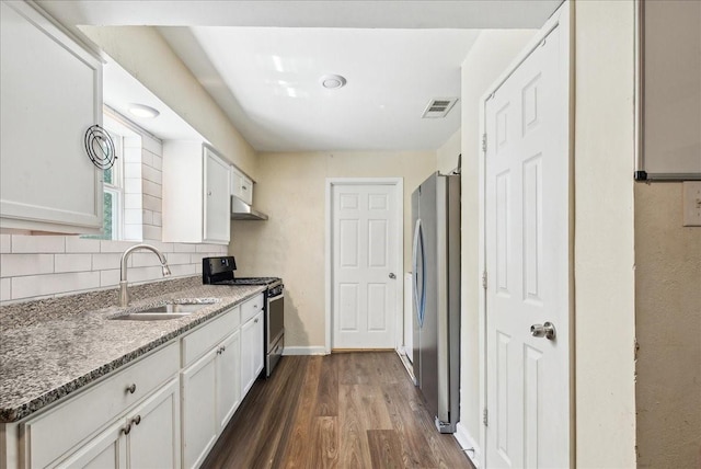 kitchen with stainless steel appliances, sink, white cabinets, and stone counters