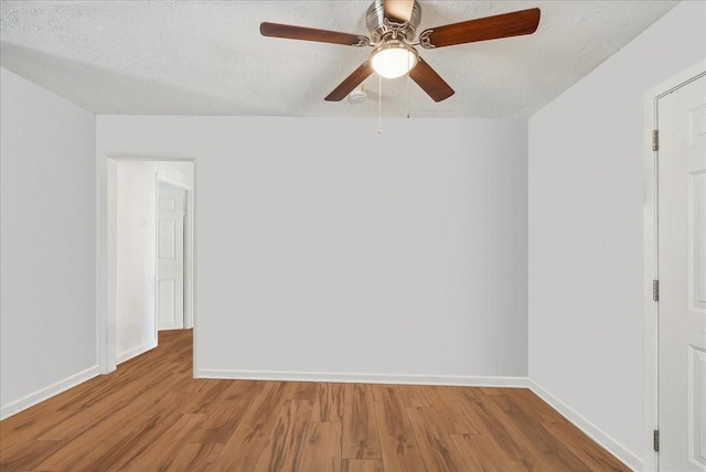 unfurnished room with ceiling fan, light hardwood / wood-style flooring, and a textured ceiling