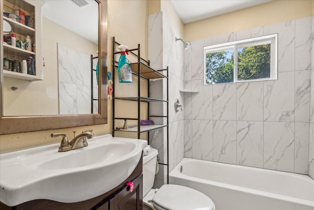 full bathroom with vanity, toilet, and tiled shower / bath