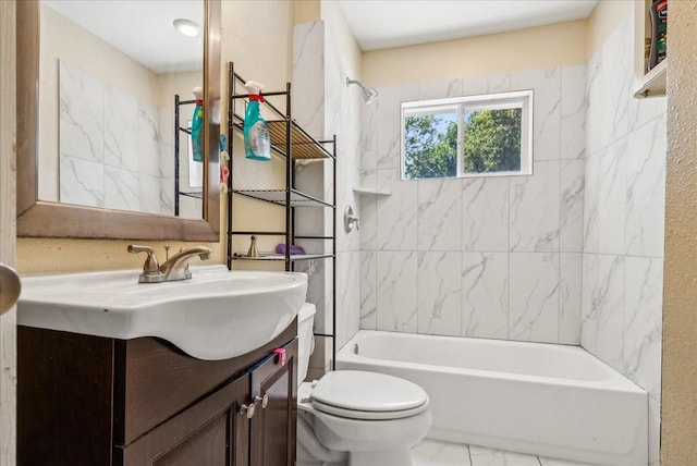 full bathroom with vanity, tiled shower / bath combo, and toilet