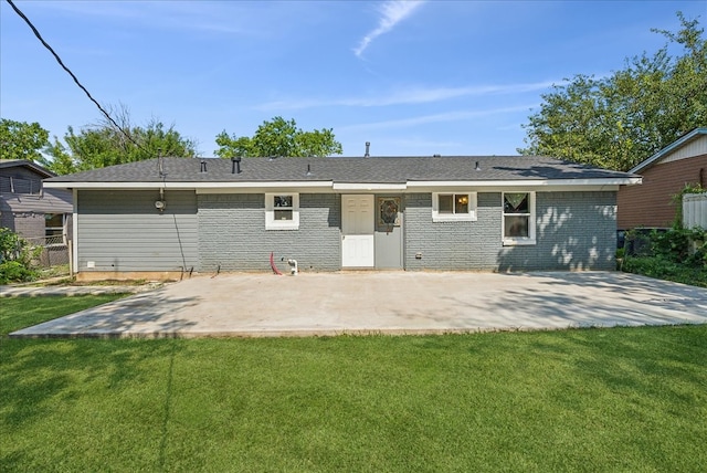 back of house featuring a patio area and a lawn