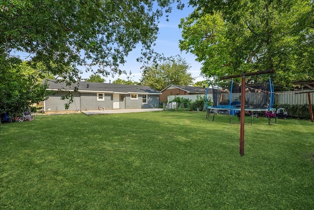 view of yard with a patio area and a trampoline