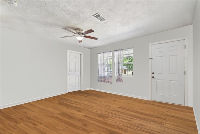 spare room featuring hardwood / wood-style floors, a textured ceiling, and ceiling fan