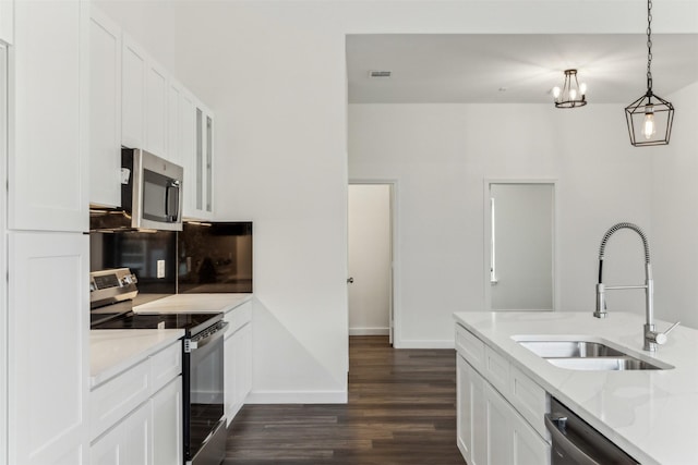 kitchen featuring white cabinetry, sink, stainless steel appliances, and light stone countertops