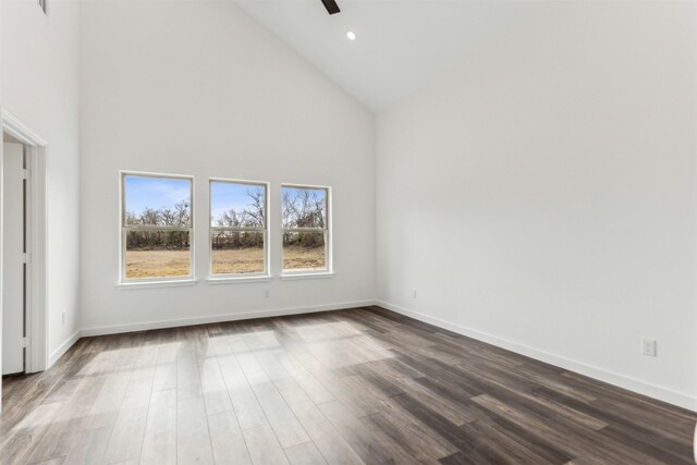 interior space with ceiling fan, dark wood-type flooring, and high vaulted ceiling