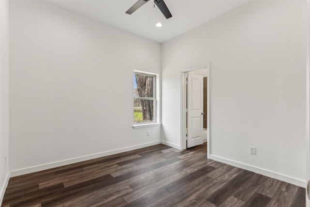 empty room with dark wood-type flooring and ceiling fan