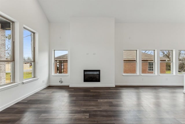 unfurnished living room with dark hardwood / wood-style flooring