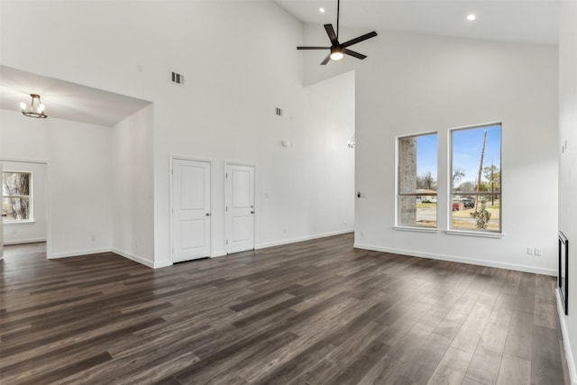 unfurnished living room with dark hardwood / wood-style flooring, vaulted ceiling, and ceiling fan