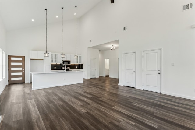 unfurnished living room featuring dark wood-type flooring