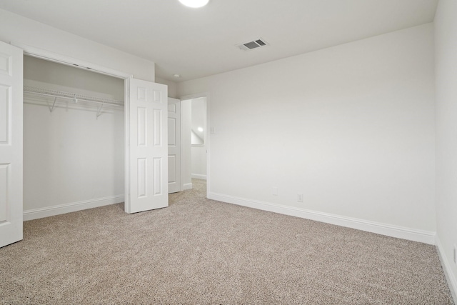 unfurnished bedroom with a closet and carpet