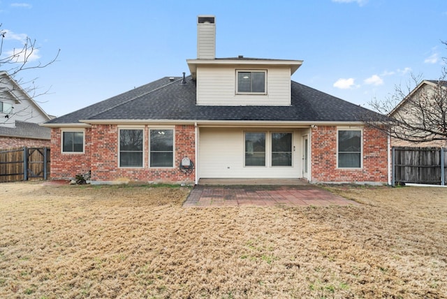 rear view of property with a patio area and a lawn