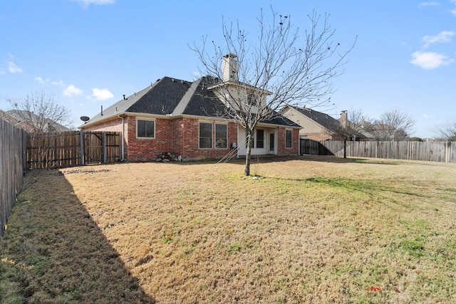 rear view of property with a yard