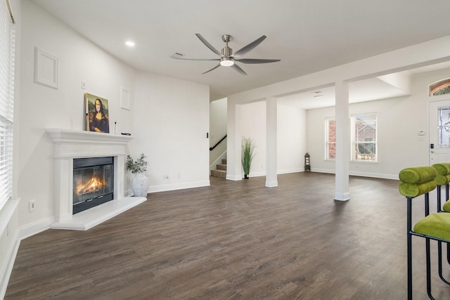 living room featuring dark hardwood / wood-style floors and ceiling fan