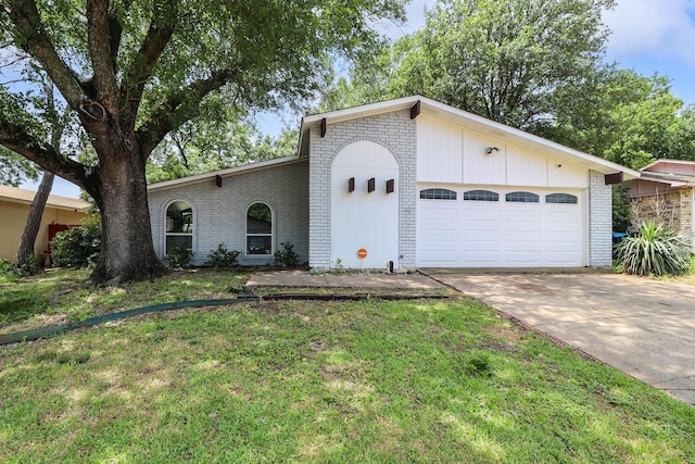 ranch-style home featuring a garage and a front lawn