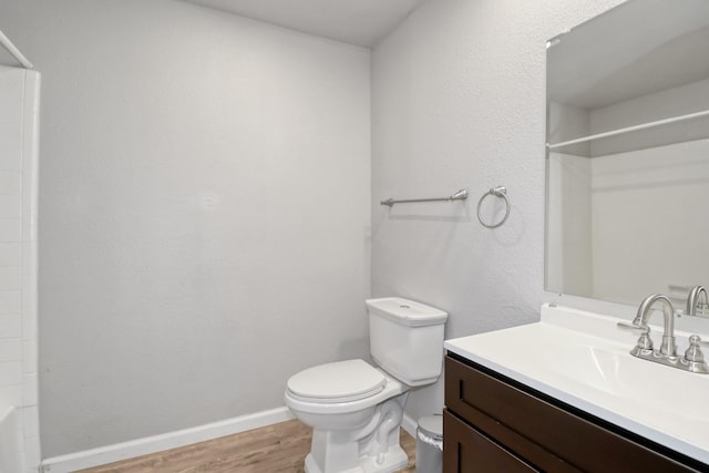 bathroom with vanity, hardwood / wood-style floors, and toilet