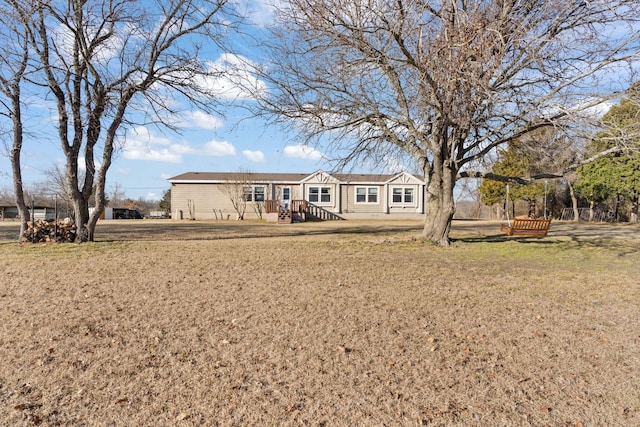 rear view of property featuring a lawn