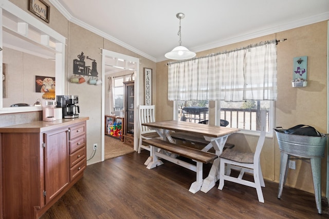 dining room featuring ornamental molding and dark hardwood / wood-style floors