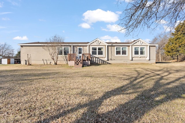 rear view of house featuring a lawn