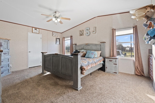 carpeted bedroom with vaulted ceiling, ceiling fan, and crown molding