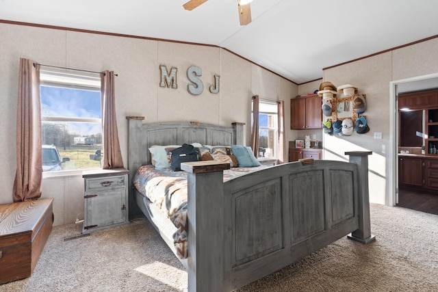 bedroom featuring vaulted ceiling, carpet flooring, ceiling fan, and crown molding