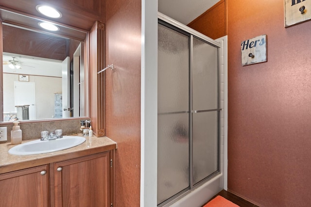 bathroom featuring vanity, ceiling fan, and walk in shower