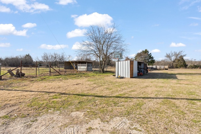 view of yard with an outbuilding and a rural view