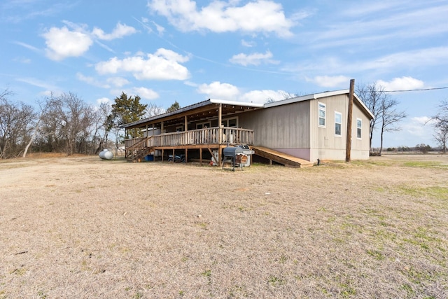 view of front of home with a wooden deck and a front yard